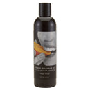 Earthly Body Edible Massage Oil Mango 8 Oz bottle showcasing a person enjoying mango flavor.