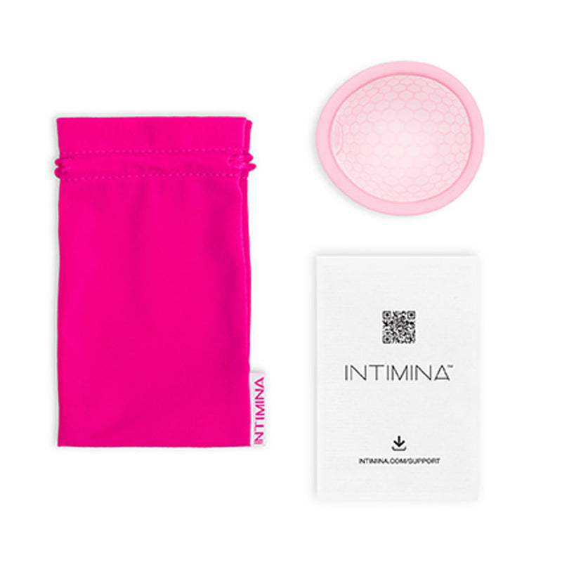 INTIMINA Ziggy Cup 2 Flat Fit Menstrual Cup Size A with pink storage bag and instruction card.