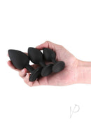 Renegade Triple Ace Silicone Anal Plugs Kit 3 Piece Black held in a hand, showcasing three sizes for versatile anal play.