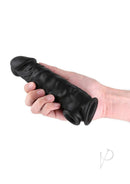Renegade Annex Silicone Penis Extension Thick Chocolate held in hand with realistic detail and texture.