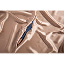 Deia The Feather Vibrating Tickler Silicone Blue nestled in luxurious satin fabric.