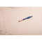 Deia The Feather Vibrating Tickler Silicone Blue floating on a serene surface, showcasing its sleek design.