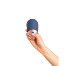 Deia The Arouser Pulsating External Stimulator Silicone Blue held in hand, showcasing its sleek design and button.