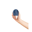 Deia The Arouser Pulsating External Stimulator Silicone Blue held in hand against a white background.