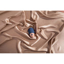 Deia The Arouser Pulsating External Stimulator Silicone Blue on silk fabric.