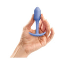 B-Vibe Snug Plug 1 Weighted Silicone Anal Plug Violet held in a hand, showcasing its compact design.