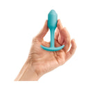 b-Vibe Snug Plug 1 Weighted Silicone Anal Plug Mint held in a hand, showcasing its compact design and silicone finish.
