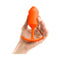 b-Vibe Snug Plug 3 Weighted Silicone Anal Plug Orange held in hand for anal play.