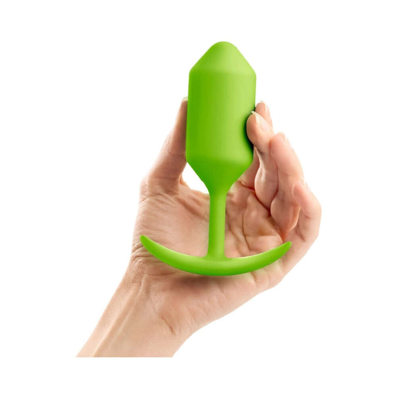 b-Vibe Snug Plug 3 Weighted Silicone Anal Plug Lime held in hand, showcasing its ergonomic design.