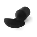 b-Vibe Snug Plug 7 Weighted Silicone Anal Plug Black displayed at an angle showing its smooth, body-safe silicone design.