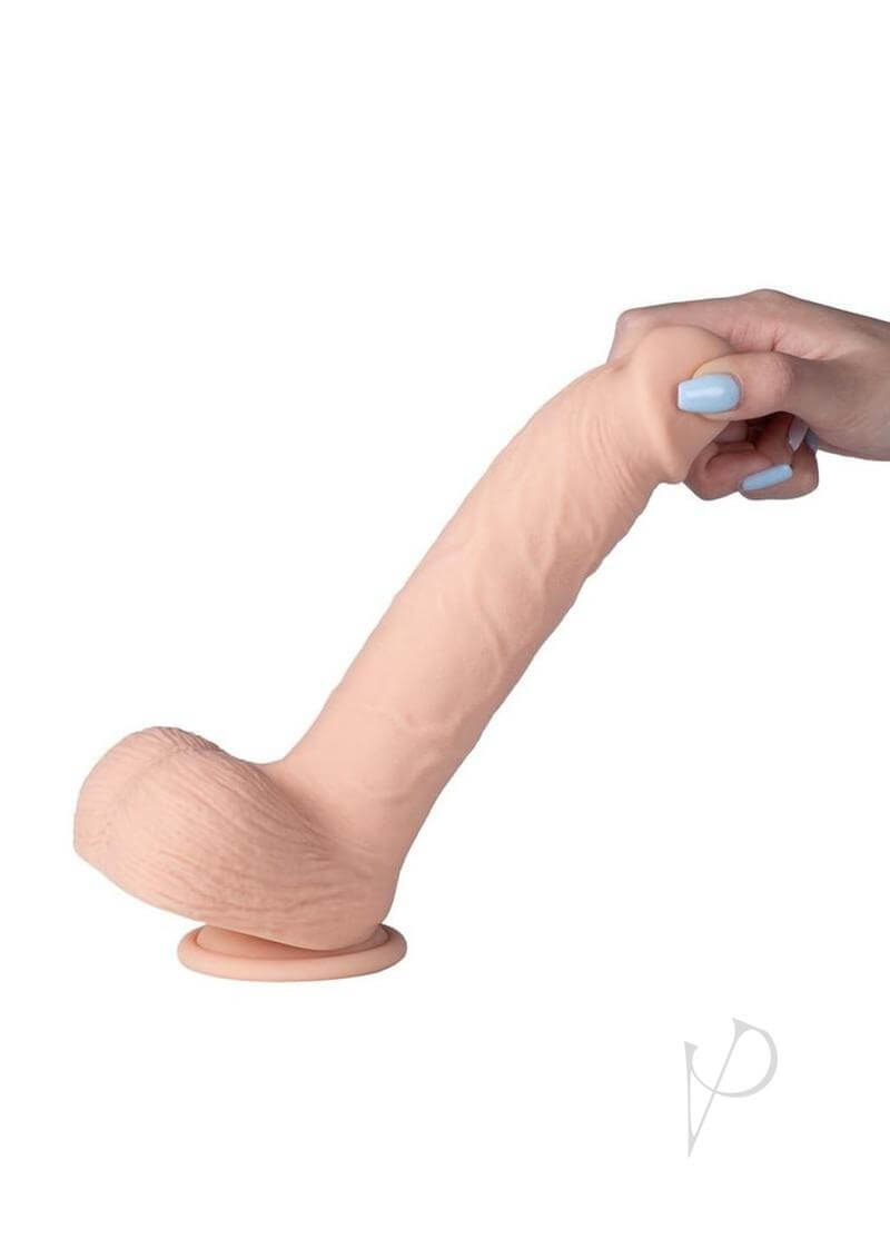 Kenzo 9.5 inches App Controlled Thrusting Dildo Caramel with realistic shape and detailed veining, held in hand.