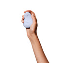 Hand holding the Dame Pom Flexible Vibrator Ice, showcasing its compact and flexible design.