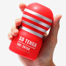 Tenga SD Original Vacuum Cup Masturbator Red held in hand showcasing its ergonomic design and vibrant color.