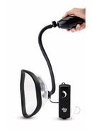 Size Up Classic Vibrating Pussy Pump Black and Clear with flexible hose and control unit in hand.