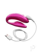 We Vibe Chorus Couples Vibrator in Pink with remote control and USB charging cable, designed for shared pleasure.