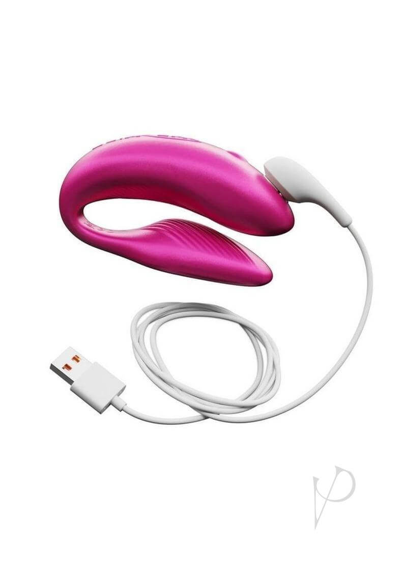 We Vibe Chorus Couples Vibrator in Pink with remote control and USB charging cable, designed for shared pleasure.