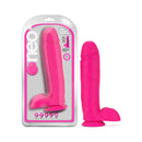 Neo 10 Inch Dual Density Dildo With Balls Neon Pink in packaging, showcasing its vivid color and realistic design.
