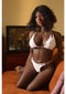 Naomi Sex Doll 158 cm Vibration Suction and Voice Chocolate in a white bikini relaxing on a couch.