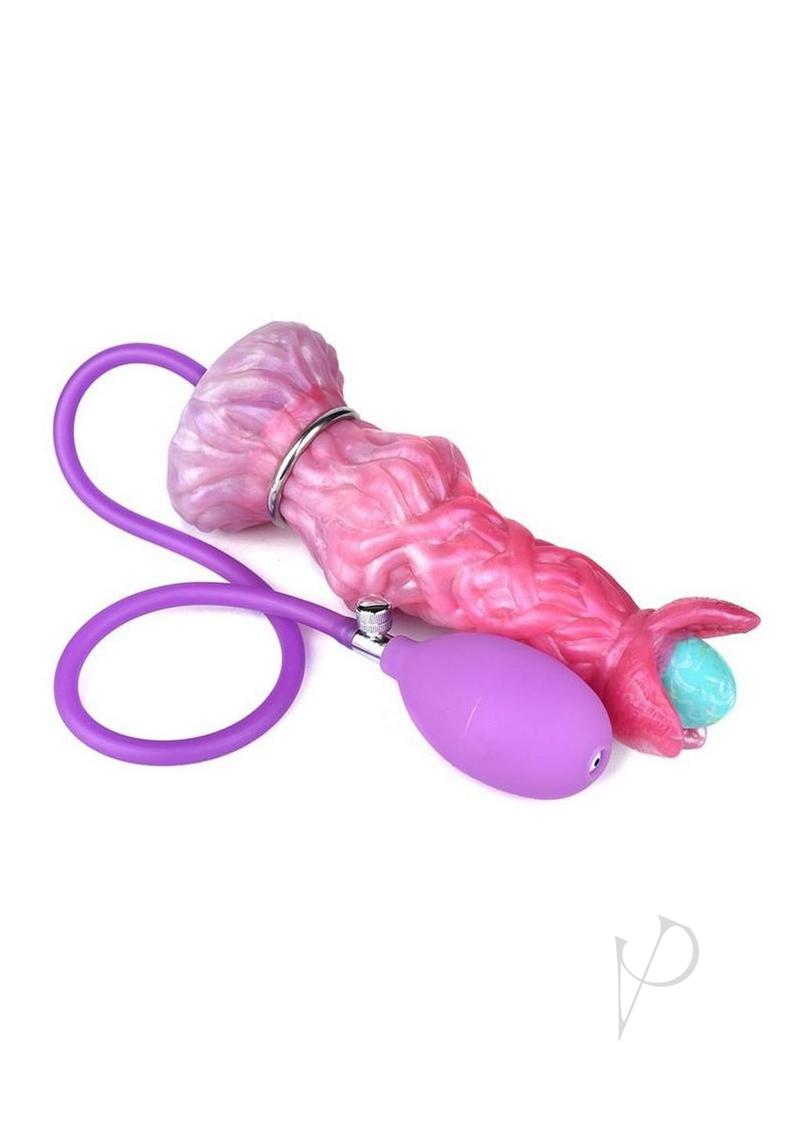 Monstar Cox Alienspawn Cock Silicone Dildo with Eggs Pink laying on a white background with a purple vibrating egg.