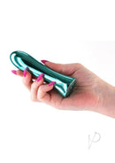 INYA Shimmer Rechargeable Metal Vibrator Teal held in hand with striking teal finish and elegant design.