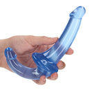 Realrock Crystal Clear 6 Inch Strapless Strap-on Dildo Blue held in hand, showcasing its unique design and eye-catching finish.