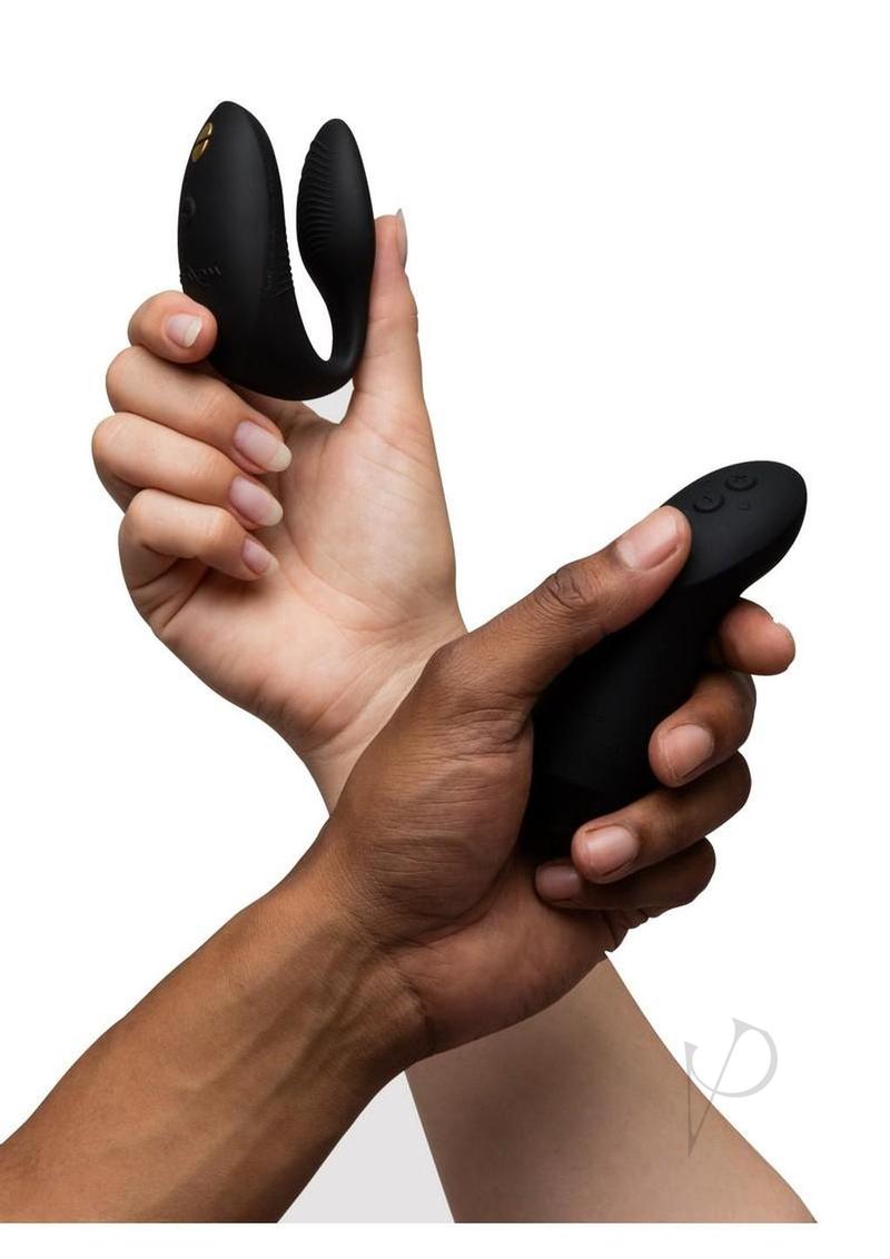 We Vibe Chorus Pro Couples Vibrator with Remote Control Black held by hands for intimate moments.