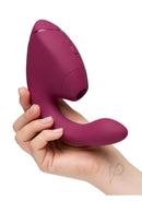 Womanizer Next Duo G-Spot and Clitoral Stimulator Dark Pink held in hand for a demonstration of its sleek design.