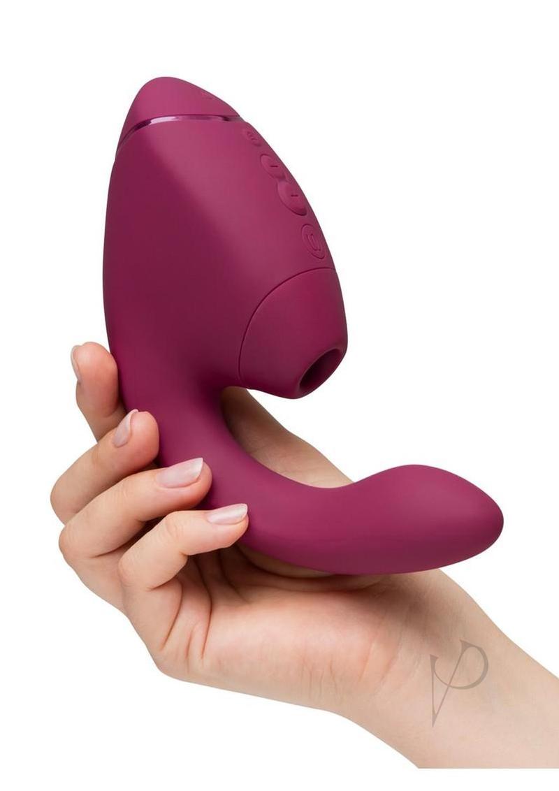 Womanizer Next Duo G-Spot and Clitoral Stimulator Dark Pink held in hand for a demonstration of its sleek design.