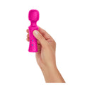 FemmeFunn Ultra Wand Mini Textured Silicone Vibrator Pink held in a hand, showcasing its ergonomic design and vibrant color.