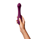 Dame Arc G-Spot Vibrator Plum held in a hand, showcasing its elegant design and silicone material.