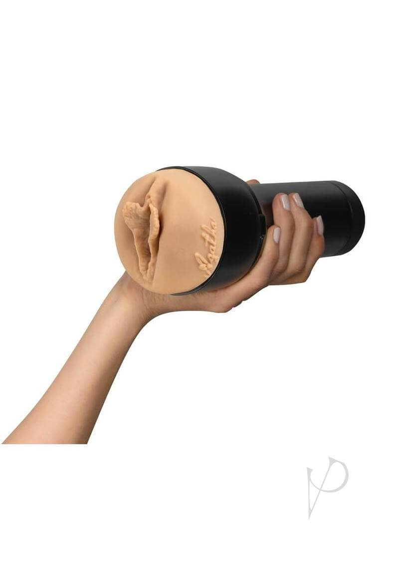 Kiiroo Feel Stars Collection Agatha Vega Stroker Pussy held in hand, featuring realistic design and detailed texture.