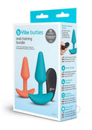 B-Vibe Butties Remote Control Anal Training Set Teal Orange packaging featuring two anal plugs and a remote.