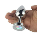 LED Light Up Metal Anal Plug Small in hand showcasing its sleek design and colorful LED light display