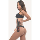 Sincerely Sportsheets Amber Layered Spanker Tortoiseshell displayed by a model in stylish black lingerie.