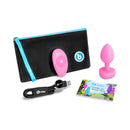 b-Vibe Vibrating Heart Anal Plug Small Medium Pink, remote, USB charger, and guide for anal play in a stylish pouch.