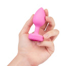 b-Vibe Vibrating Heart Anal Plug Small Medium Pink held in hand, displaying its design and functionality.