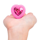 b-Vibe Vibrating Heart Anal Plug Small Medium Pink held in hand with heart-shaped jewel design.