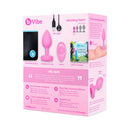 b-Vibe Vibrating Heart Anal Plug Small Medium Pink package, includes USB charger, guide, and travel bag.