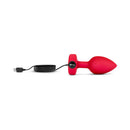 b-Vibe Vibrating Heart Anal Plug Medium Large Red with USB charging cable and control, featuring a sleek design.