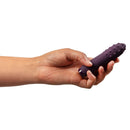 Je Joue Duet Multi-Surfaced Bullet Vibrator Purple being held in hand, showcasing its sleek design and textured surface.
