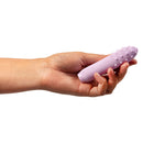 Je Joue Duet Multi-Surfaced Bullet Vibrator Lilac held in hand showcasing its textured design.