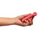 Je Joue Vita Wand Tip Bullet Vibrator Watermelon Pink held in a hand, showcasing its compact design.