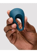 We-Vibe Pivot 2 Silicone Vibrating Cock Ring Slate held in hand to demonstrate its ergonomic design and features.
