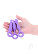 INYA Trio 3 Piece Silicone Anal Plug Kit Purple displayed in hand, showcasing three slim anal plugs for comfortable exploration.