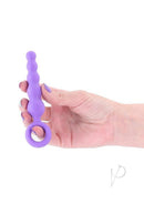 INYA Slip Silicone Anal Plug Purple held in hand showing tapered design and finger ring for easy handling.