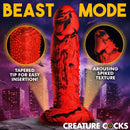 Creature Cocks Gojira Silicone Dildo with tapered tip and spiked texture in a vibrant setting.