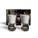 Neo Sensual Celebrate Duo Massage Candles 1 Oz displayed in elegant crystal shot glasses with gold leaf.
