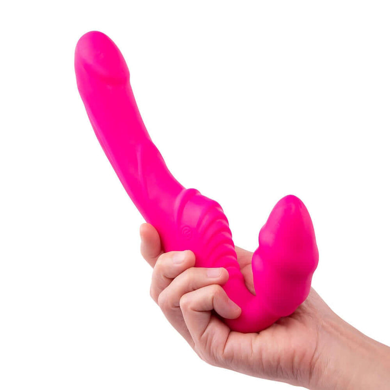Together Strapless Remote Control Vibrator Pink held in hand, showcasing its sleek design and vibrant color.