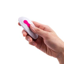 Hand holding the remote for Together Strapless Remote Control Vibrator Pink, designed for couples' pleasure.