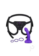 B-Vibe Vibrating Curved Silicone Strap-On Kit Black Purple with ergonomic harness and purple dildo.